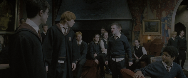 Wide shot frame from Harry Potter and the Order of the Phoenix — sitting, standing, room