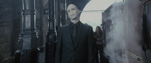 Wide shot frame from Harry Potter and the Order of the Phoenix — standing, suit, face
