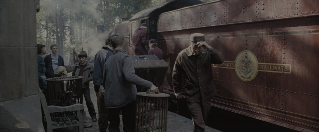 Wide shot frame from Harry Potter and the Order of the Phoenix — standing, train, smoke