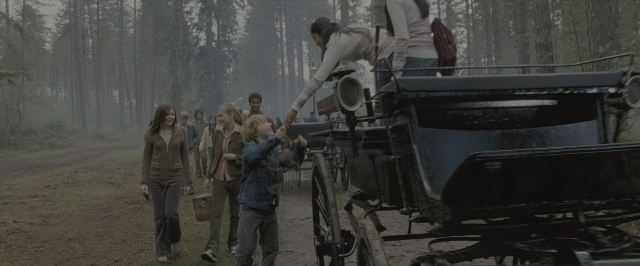 Wide shot frame from Harry Potter and the Order of the Phoenix — standing, walking, street
