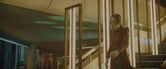 Wide shot frame from John Wick: Chapter 4 — standing, coat, face