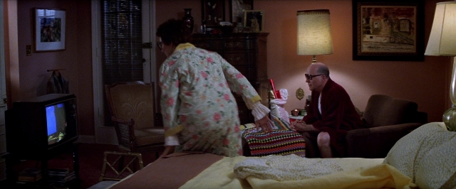 Frame from Man on the Moon — sitting, standing, room