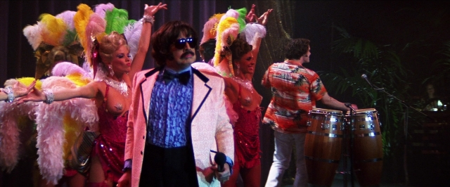 Wide shot frame from Man on the Moon — standing, suit, dress