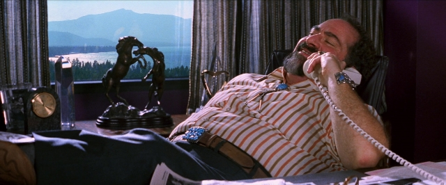 Wide shot frame from Man on the Moon — bed, phone, shirt
