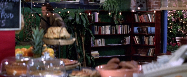 Frame from Man on the Moon — book, table, food