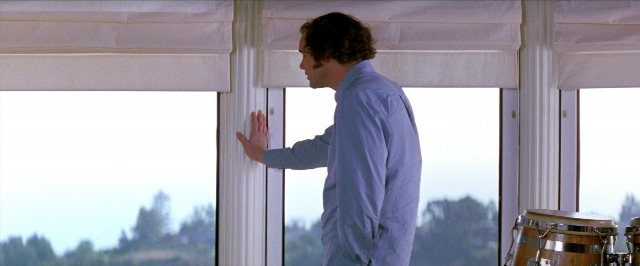 Frame from Man on the Moon — standing, hand, shirt