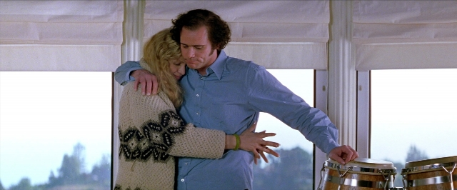 Wide shot frame from Man on the Moon — standing, shirt, hug