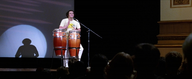 Wide shot frame from Man on the Moon — standing, dialogue, shirt