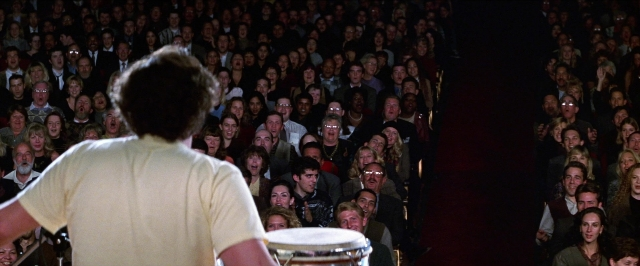 Wide shot frame from Man on the Moon — shirt, drum, person