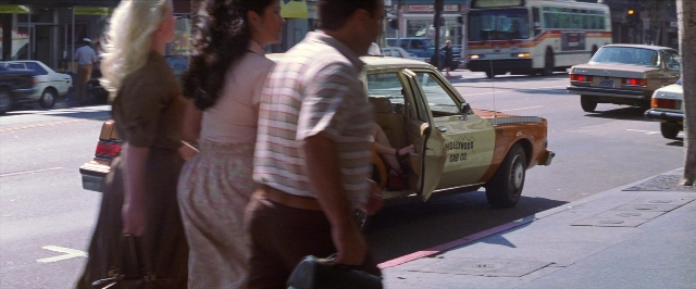 Wide shot frame from Man on the Moon — standing, street, car