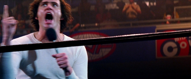 Wide shot frame from Man on the Moon — standing, hand, shirt