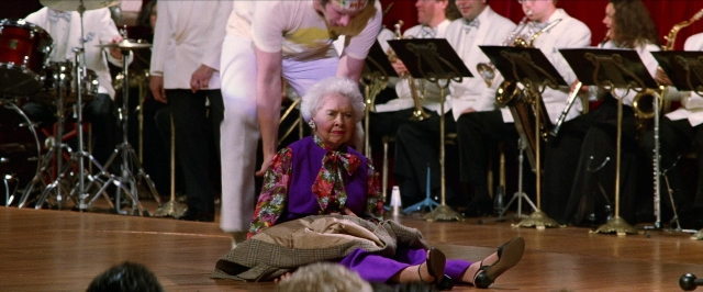 Wide shot frame from Man on the Moon — sitting, dress, hair
