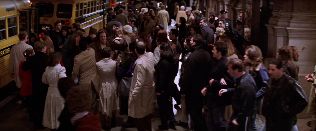 Wide shot frame from Man on the Moon — standing, dialogue, street