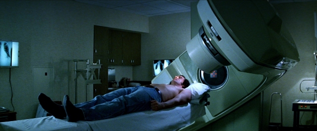 Wide shot frame from Man on the Moon — room, bed, face
