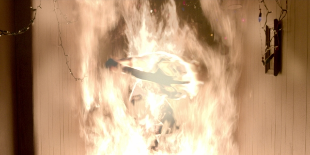 Frame from Stranger Things — fire, smoke, person