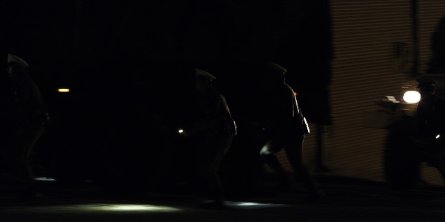 Wide shot frame from Stranger Things — walking, street, night