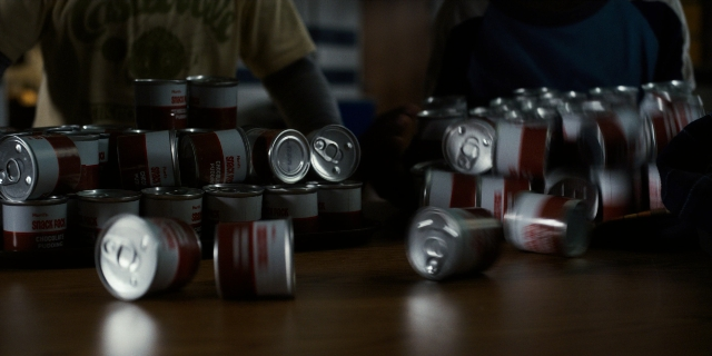 Wide shot frame from Stranger Things — table, kitchen, person