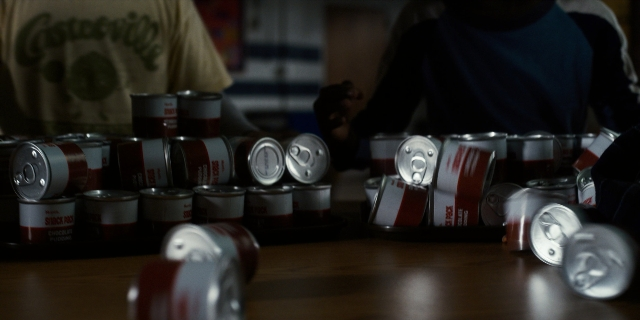 Wide shot frame from Stranger Things — room, table, shirt