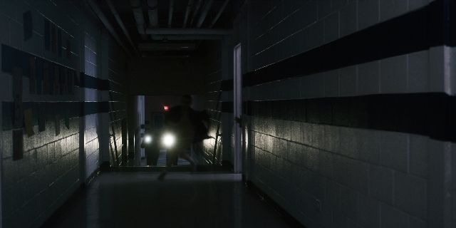 Wide shot frame from Stranger Things — walking, person, running
