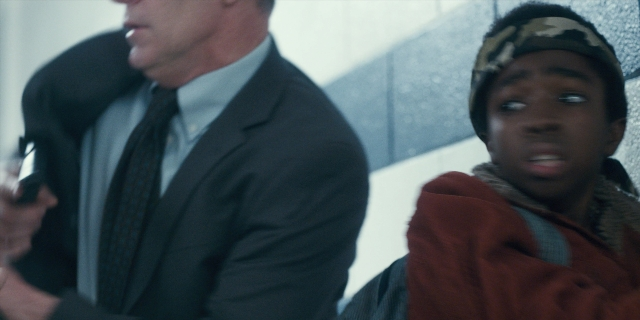 Wide shot frame from Stranger Things — sitting, phone, hand