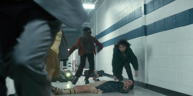 Wide shot frame from Stranger Things — standing, shirt, person