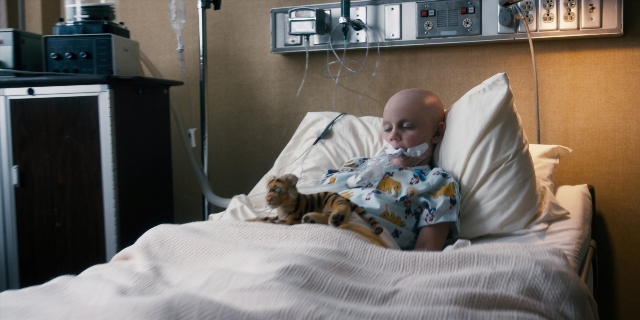 Wide shot frame from Stranger Things — bed, person, human face