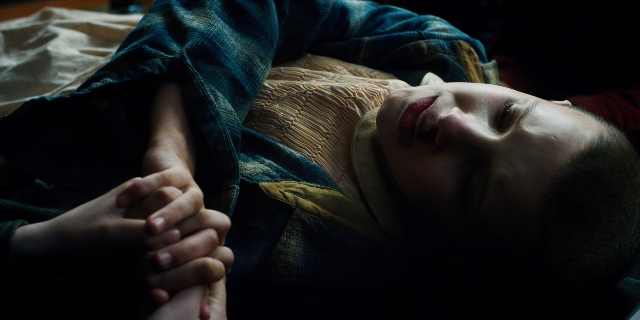 Wide shot frame from Stranger Things — bed, shirt, person