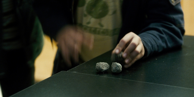 Wide shot frame from Stranger Things — standing, room, table