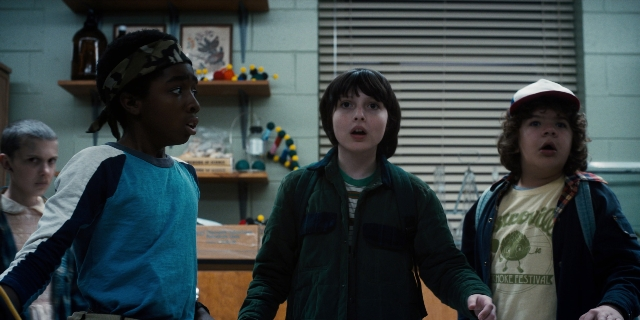 Wide shot frame from Stranger Things — standing, room, dialogue