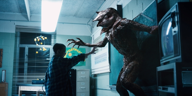 Wide shot frame from Stranger Things — standing, room, hand