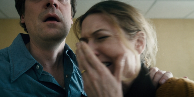 Wide shot frame from Stranger Things — room, shirt, face