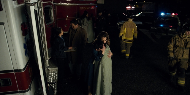 Wide shot frame from Stranger Things — standing, walking, street