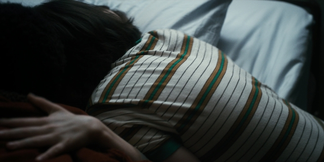 Frame from Stranger Things — bed, shirt, person