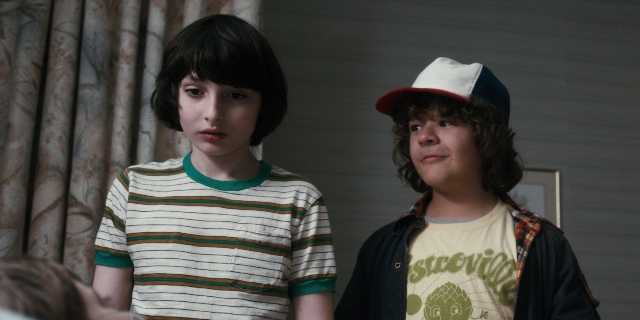 Wide shot frame from Stranger Things — standing, room, dialogue