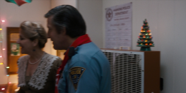 Wide shot frame from Stranger Things — standing, room, dress