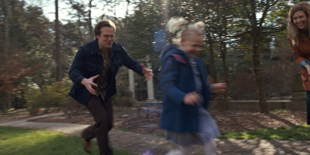 Wide shot frame from Stranger Things — standing, coat, jacket