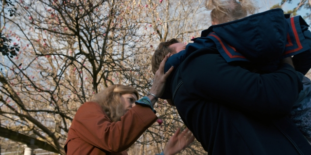 Wide shot frame from Stranger Things — standing, hug, person