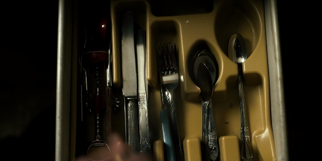 Wide shot frame from Stranger Things — bottle, knife, spoon