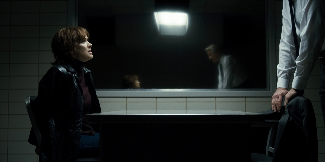 Wide shot frame from Stranger Things — sitting, standing, room
