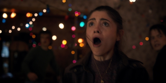 Wide shot frame from Stranger Things — standing, room, hair