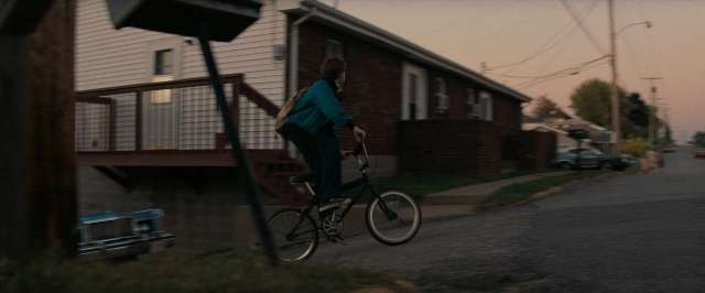 Frame from Super 8 — street, car, bicycle