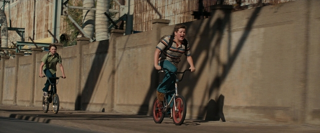 Wide shot frame from Super 8 — street, bicycle, shirt