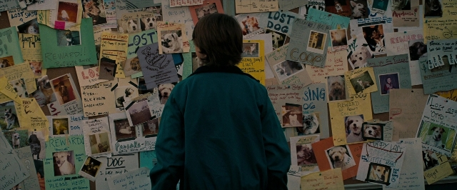 Wide shot frame from Super 8 — standing, dog, poster