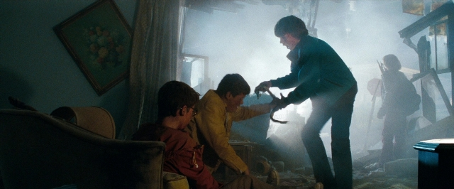 Wide shot frame from Super 8 — sitting, standing, room