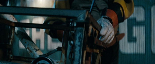 Frame from Super 8 — hat, hand, wheel