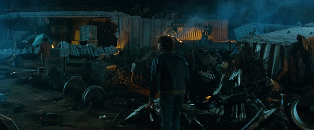 Wide shot frame from Super 8 — standing, night, face