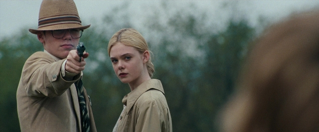 Wide shot frame from Super 8 — standing, hat, coat