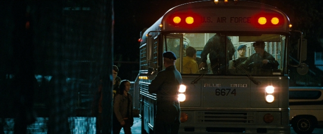 Wide shot frame from Super 8 — standing, street, uniform