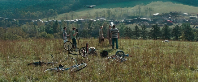 Frame from Super 8 — standing, bicycle, person