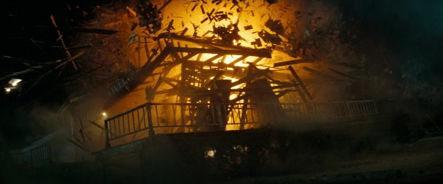 Wide shot frame from Super 8 — fire, night, house